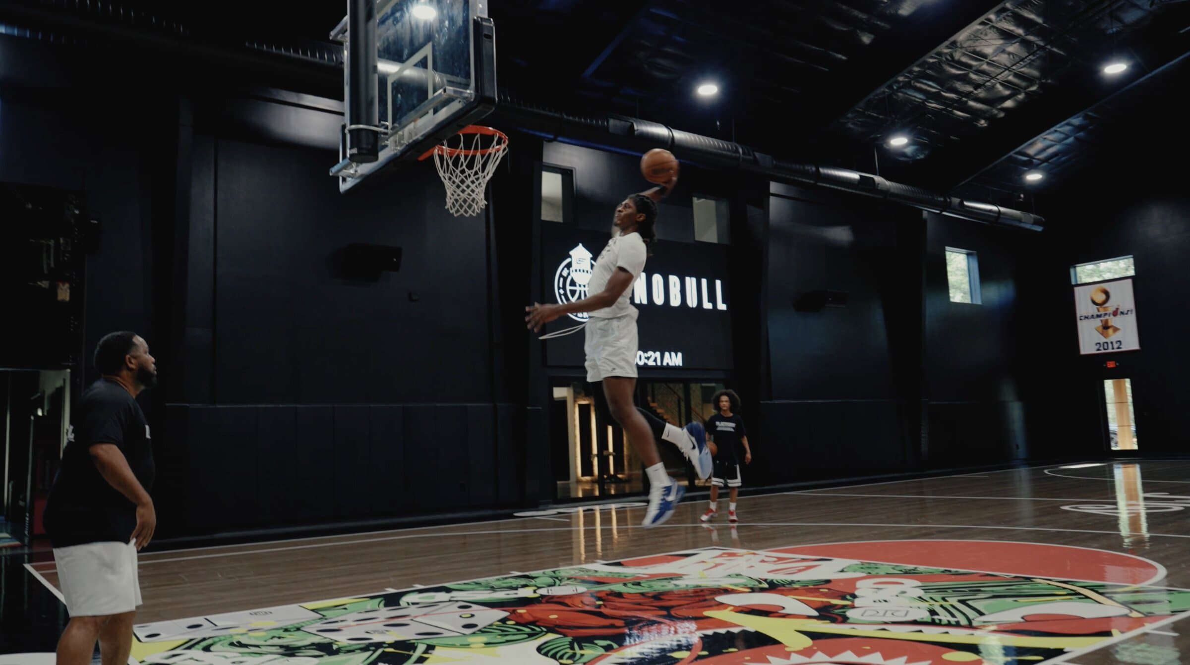A draft prospect rising for a dunk inside a private training facility