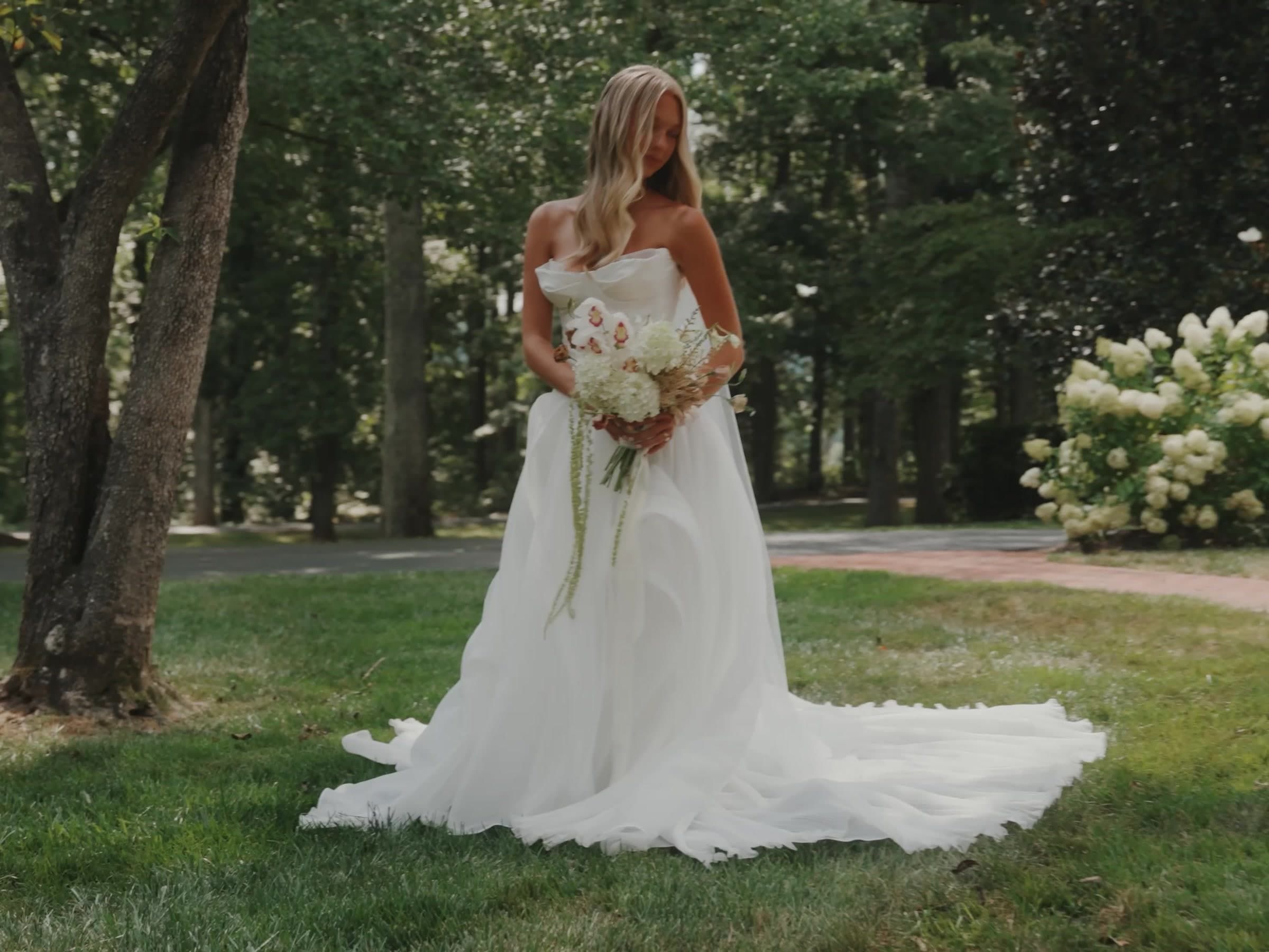Brooke in her wedding dress under the trees