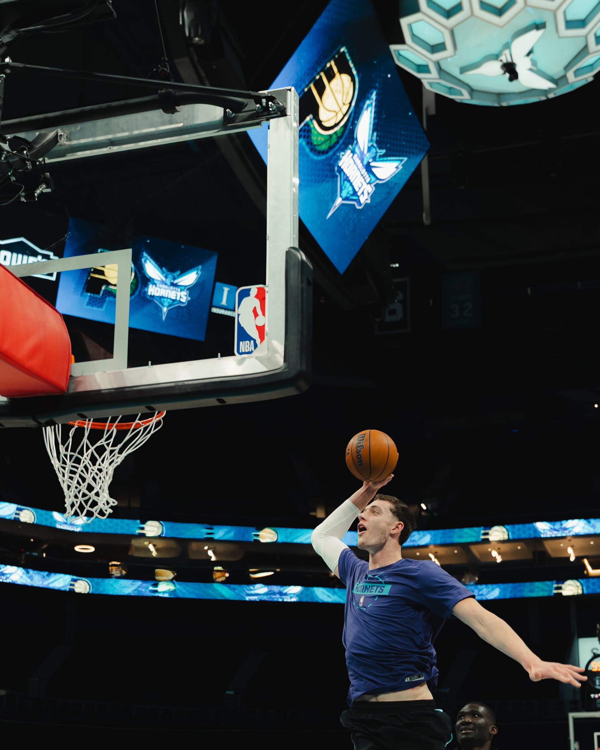 The ball above the rim under NBA arena lights