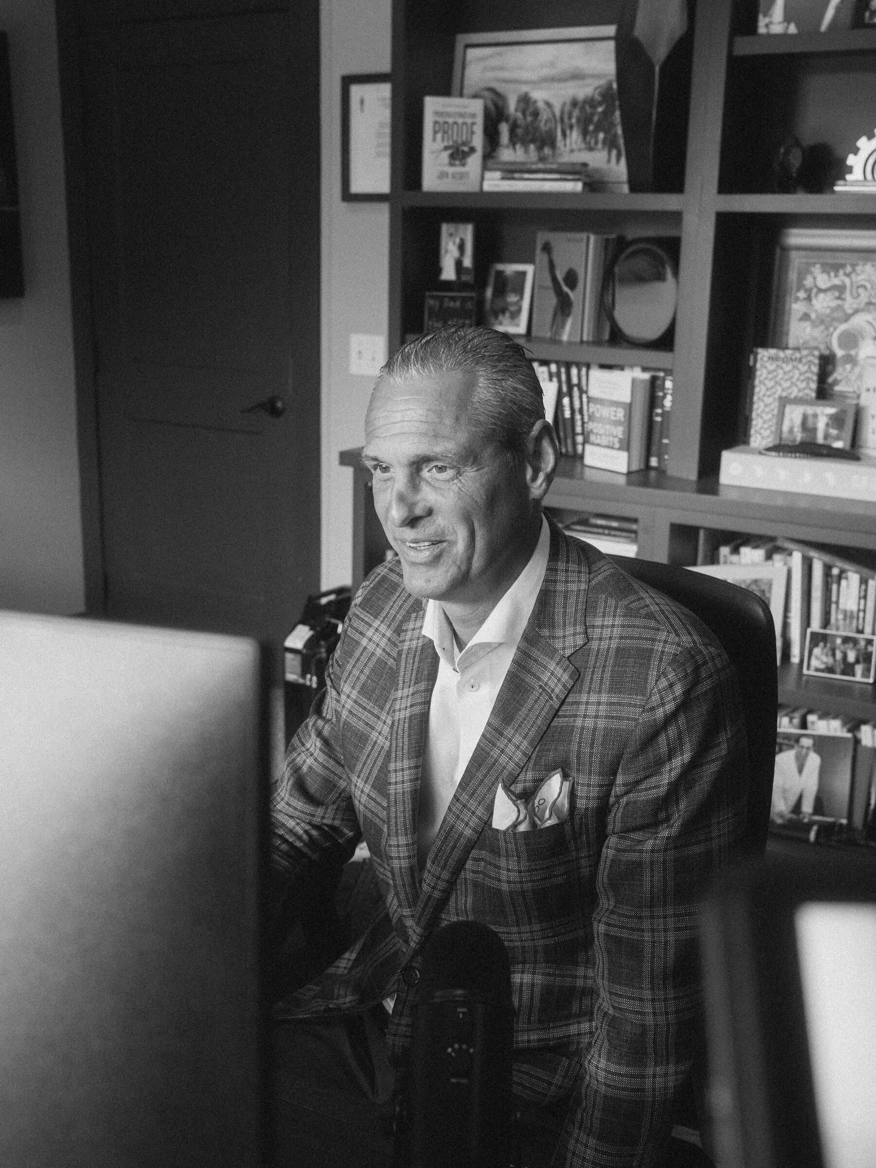 Nathan Unruh at his desk between takes, in black and white