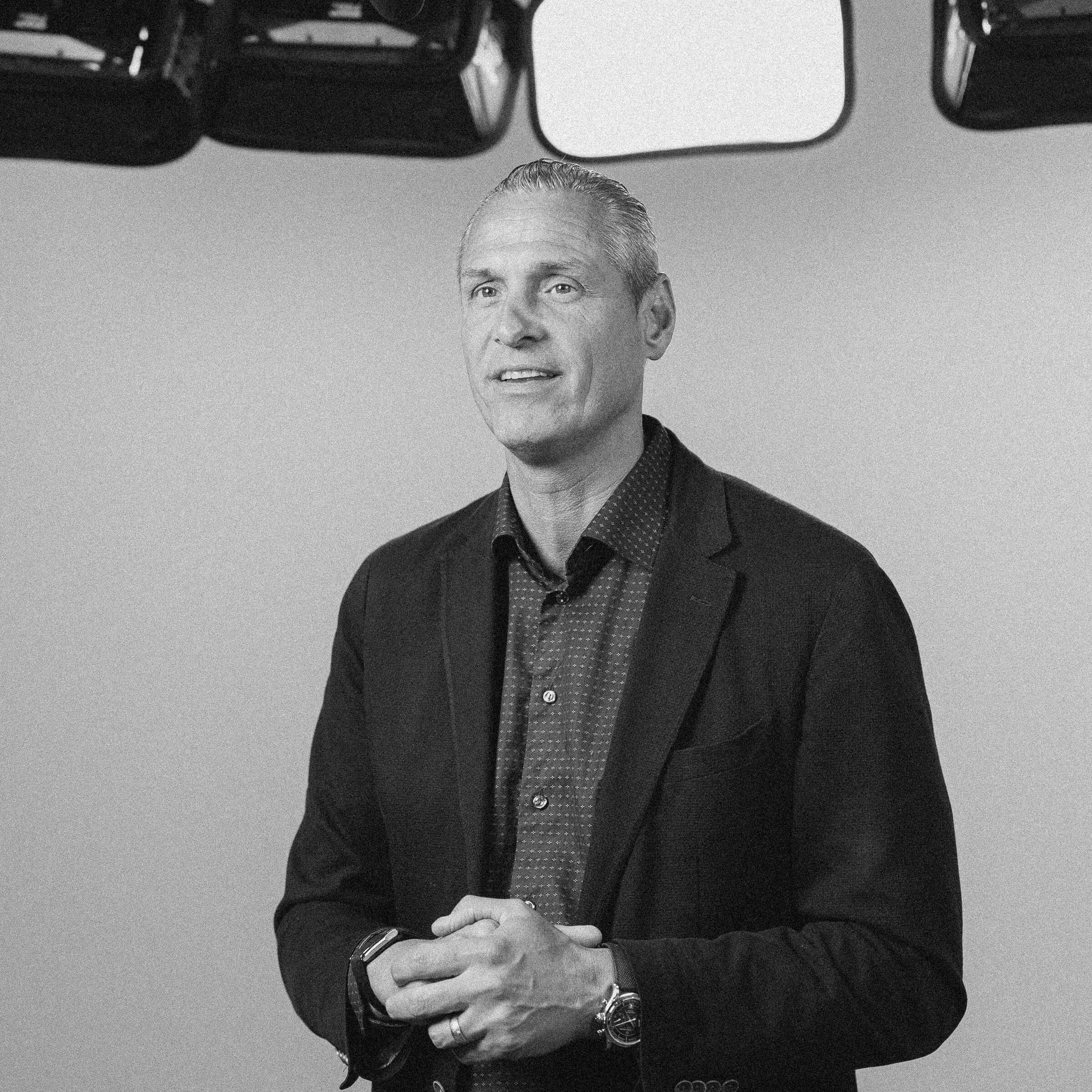 Black-and-white standing portrait of Nathan Unruh in the studio