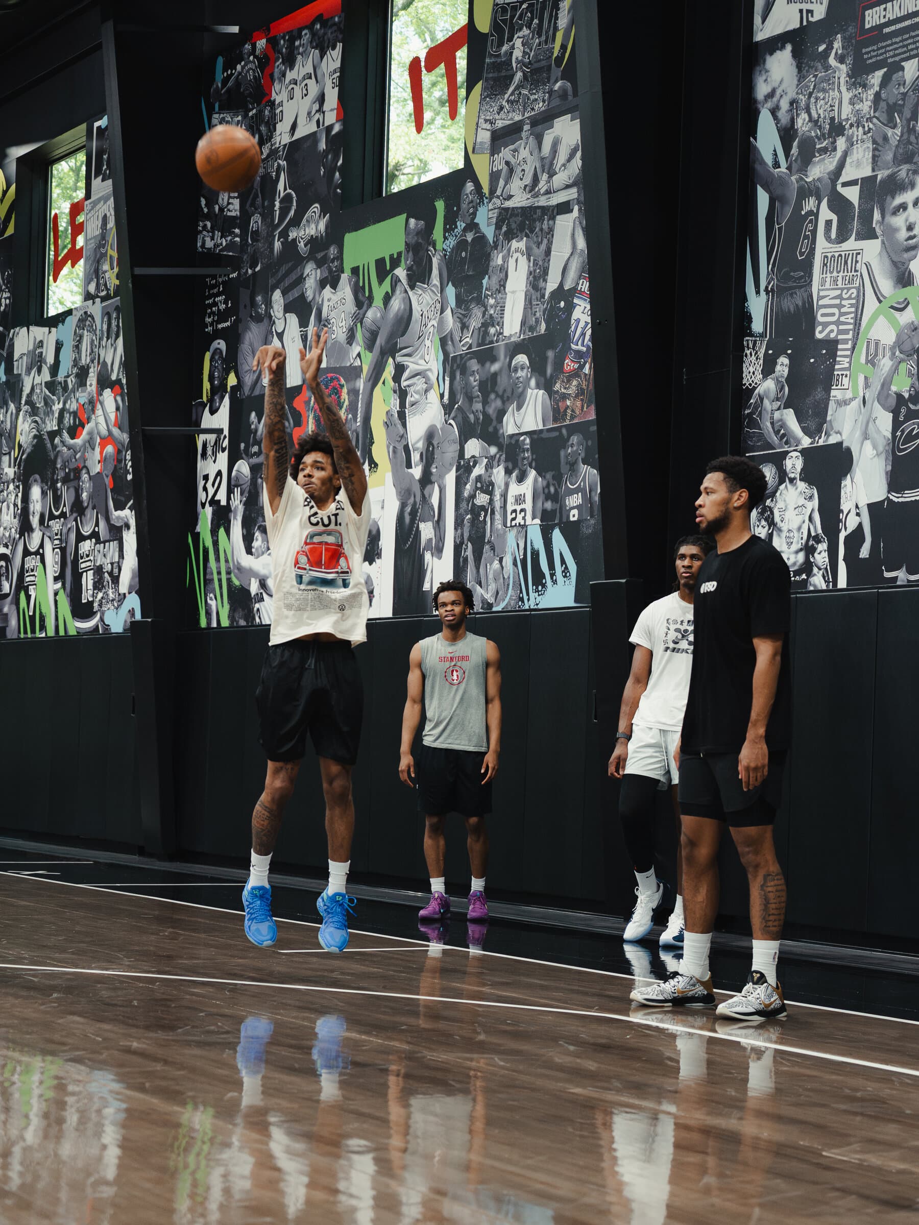 A player elevating for a jump shot in front of a mural wall